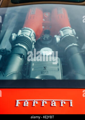 Red Ferrari F458 clear mid-engine compartment and name badge. Stock Photo