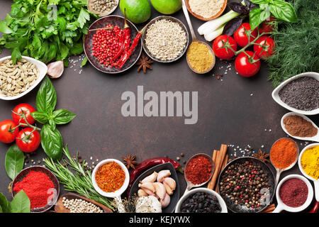 Various spices and herbs frame on stone table. Top view with space for your text Stock Photo