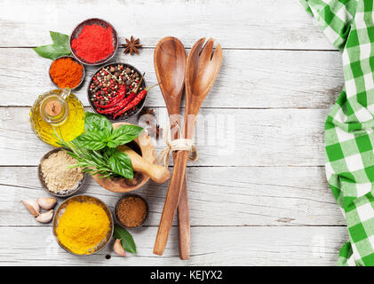 Various spices and herbs on wooden table. Top view with space for your text Stock Photo