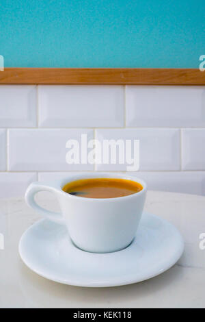 cup of americano coffee ready to serve on the marble table in the coffee shop in the morning. Stock Photo