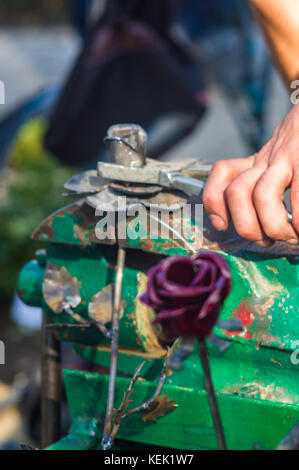 blacksmith and apprentice are made of iron rose handmade Stock Photo