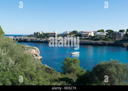 Boat sailing in Cala Marcal, a beautiful tourist area in the southeast of Mallorca Stock Photo