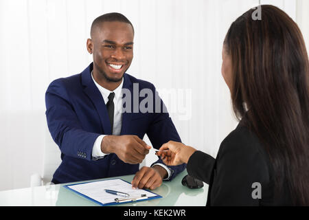 Two Successful Business Executive Exchanging Business Card Stock Photo