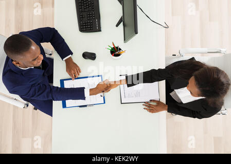 High Angle View Of Two Businesspeople Shaking Hand Stock Photo