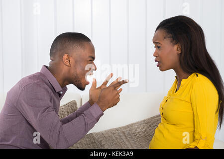 Angry Young African Man Screaming At Woman Stock Photo