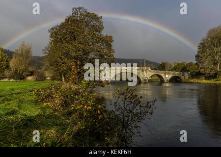 Aberfeldy, Scotland, UK. 22nd October, 2017. A rainbow arches over the top of the Tay Bridge in Aberfeldy. Opened in 1735 by General Wade and designed by William Adam, the bridge still carries road traffic from the Highlands int Aberfeldy. Credit: Rich Dyson/Alamy Live News Stock Photo