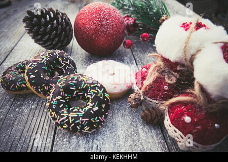 homemade sweet donuts with Christmas decorations,on wooden board Stock Photo