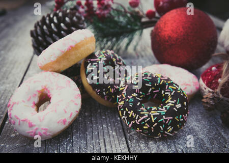 homemade sweet donuts with Christmas decorations,on wooden board Stock Photo