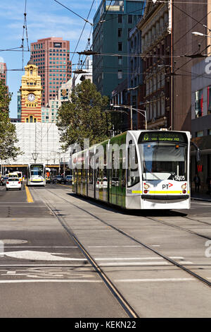 A modern tram travels along Elizabeth Street in Melbourne Victoria Australia. Stock Photo