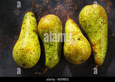Fresh green long pears on rustic metal sheet. Abate fetel. Conference Stock Photo
