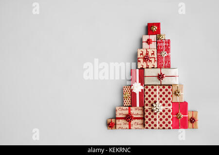 Christmas gift boxes laid out in the shape of a Christmas tree, overhead view Stock Photo