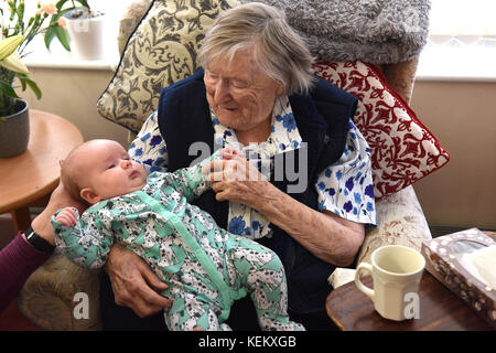 102 year old great grandmother meeting her great grandchild for the first time. centenarian 100 years old year young an old Stock Photo
