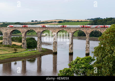 The Virgin Azuma train crosses Royal Border Bridge at Berwick upon Tweed travelling north on its first journey to Scotland. Stock Photo