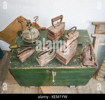 Ancient irons on a timber floor. Reconstruction of life of Cossacks of Kuban. Stock Photo