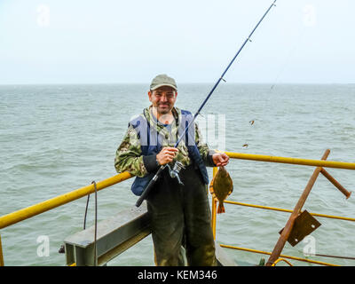 Flounder on the deck. Fishing on the boat. Bottom fish. Stock Photo