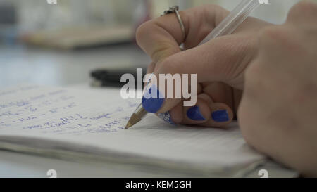 Girl considers checks on the calculator. Hands woman calculator money. Female office workers holding are arranging documents of unfinished documents archive analyzing the market Stock Photo