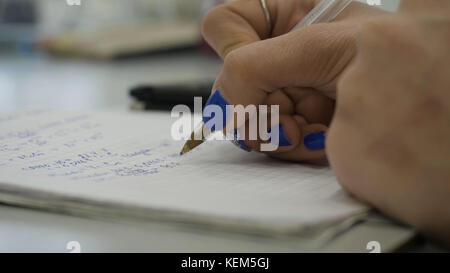 Girl considers checks on the calculator. Hands woman calculator money. Female office workers holding are arranging documents of unfinished documents archive analyzing the market Stock Photo