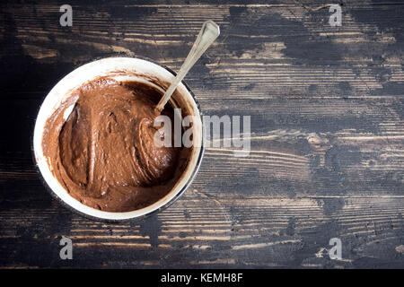 Basic homemade brownie or chocolate cake raw dough in bowl. Cooking (baking) homemade chocolate cake or brownie. Stock Photo