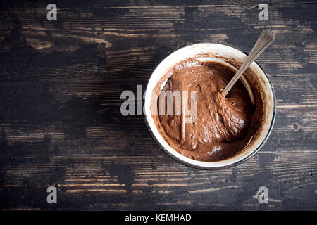 Basic homemade brownie or chocolate cake raw dough in bowl. Cooking (baking) homemade chocolate cake or brownie. Stock Photo