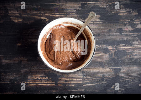 Basic homemade brownie or chocolate cake raw dough in bowl. Cooking (baking) homemade chocolate cake or brownie. Stock Photo