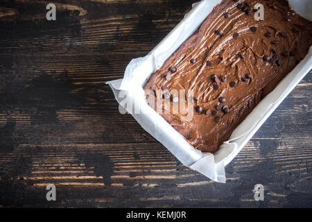 Basic homemade brownie or chocolate cake raw dough in baking pan. Cooking (baking) homemade chocolate cake or brownie. Stock Photo