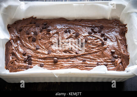 Basic homemade brownie or chocolate cake raw dough in baking pan. Cooking (baking) homemade chocolate cake or brownie. Stock Photo