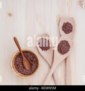 Alternative health care and dieting flax seeds in wooden spoon set up on rustic wooden background. Stock Photo