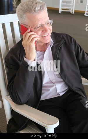 Handsome Senior Man Using Cellular Phone Stock Photo