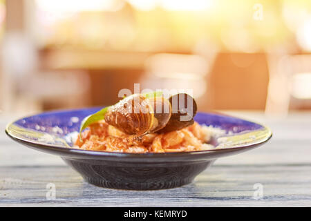 Delicious pasta with mussels on blurred background. Pasta frutti di maré. Appetizing italian food on plate. Stock Photo