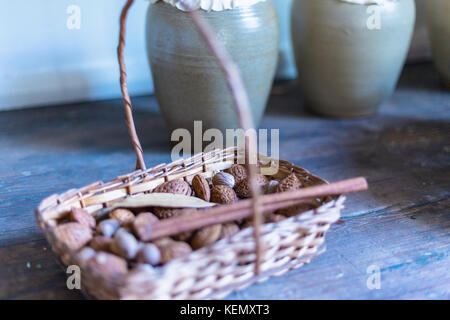 Mixed nuts in basket: hazelnuts, pecans, almonds Stock Photo