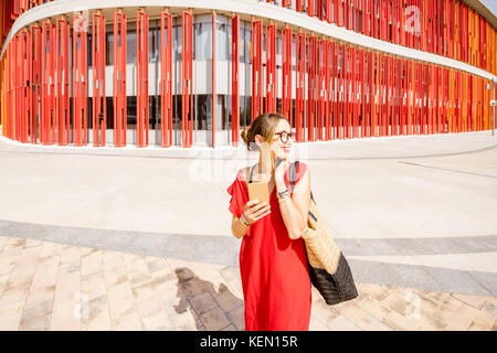 Woman on the red wall background Stock Photo