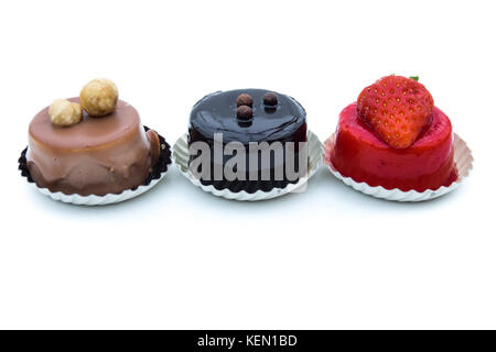 Mixed dessert - sweet pie with hazelnuts, chocolate and strawberry, isolated on white background Stock Photo
