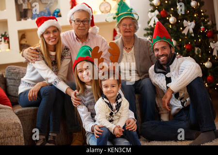 Cheerful parents with grandparents and children together for Christmas Stock Photo
