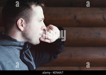 The young man thought about the problems. He looks into the distance. Side view. Stock Photo