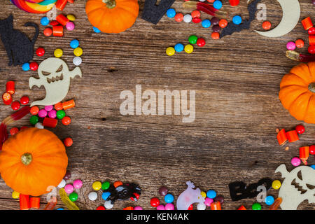 Trick and treat - colorful halloween frame on aged wood with copy space on wooden background Stock Photo