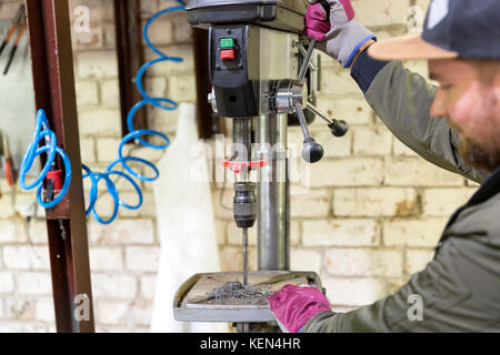 Experienced operator. Metalworking industry concept professional engineer metalworker operating milling machine center in tool manufacturing workshop Stock Photo