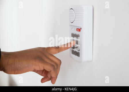 Close-up Of African Businesswoman Hand Pressing Button On Door Security System Stock Photo
