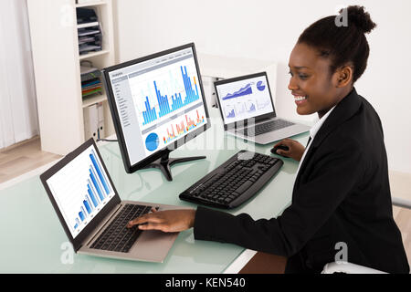 Young African Businesswoman Analyzing Graph On Computer Stock Photo