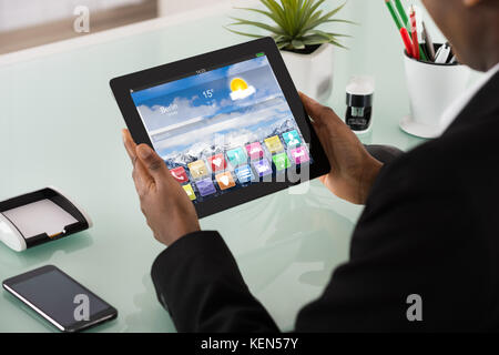 Close-up Of Businesswoman Looking At Applications On Digital Tablet Screen Stock Photo