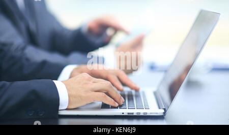 close up hands multitasking man using laptop connecting wifi Stock Photo