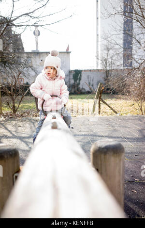 Child on a teeter-totter Stock Photo