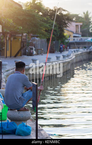 Hoi An, Vietnam - June 2017: fisherman catching fish on river in Hoi An, Vietnam. Stock Photo