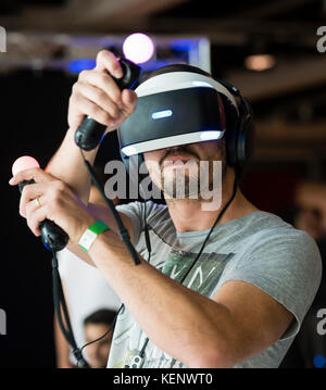 Zurich, Switzerland. 22nd Oct, 2017. A visitor of the Zurich Game Show 2017 at Zurich's exhibition centre is trying out Sony's PlayStation VR headset and Thumbstick motion controllers. Credit: Erik Tham/Alamy Live News Stock Photo