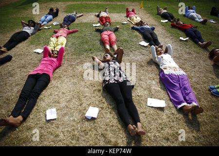 Lalitpur, Nepal. 23rd Oct, 2017. Nepalese women rest on the ground during a training exercise for the selection of temporary cops for the upcoming provincial and parliamentary elections in Lalitpur, Nepal on Monday, October 23, 2017. The government of Nepal is recruiting 98, 168 temporary police for the upcoming elections. Credit: Skanda Gautam/ZUMA Wire/Alamy Live News Stock Photo