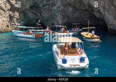tourists on boat trips visit grotta verda on the island of capri, italy.
