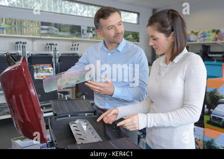 customers buying goods selecting the best tools Stock Photo