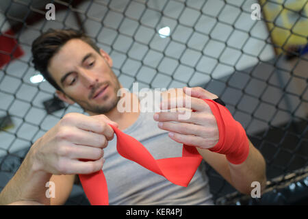 man wears red boxing bandages Stock Photo