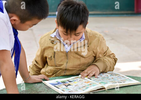 Schoolchildren reading Vientiane Laos Stock Photo