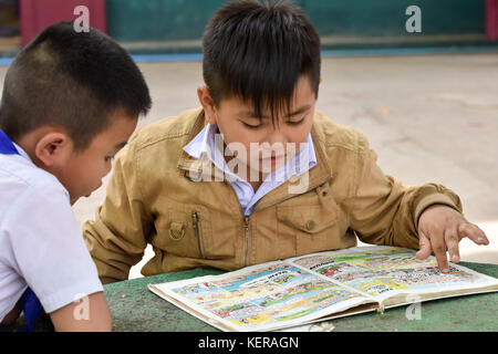 Schoolchildren reading Vientiane Laosscho Stock Photo