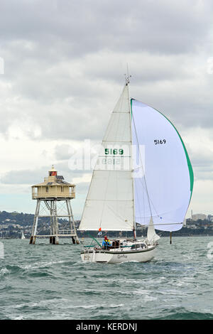 Marauder 24 yacht with spinnaker set sailing past Bean Rock lighthouse. Stock Photo